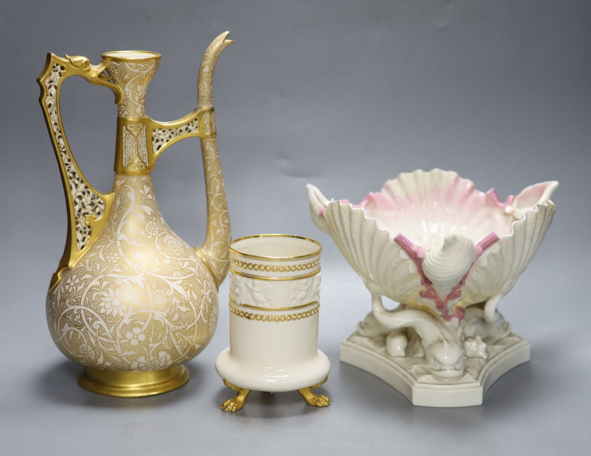 A Royal Worcester ewer, in the Persian style, a shell and dolphin centrepiece and a vase, tallest 30cm